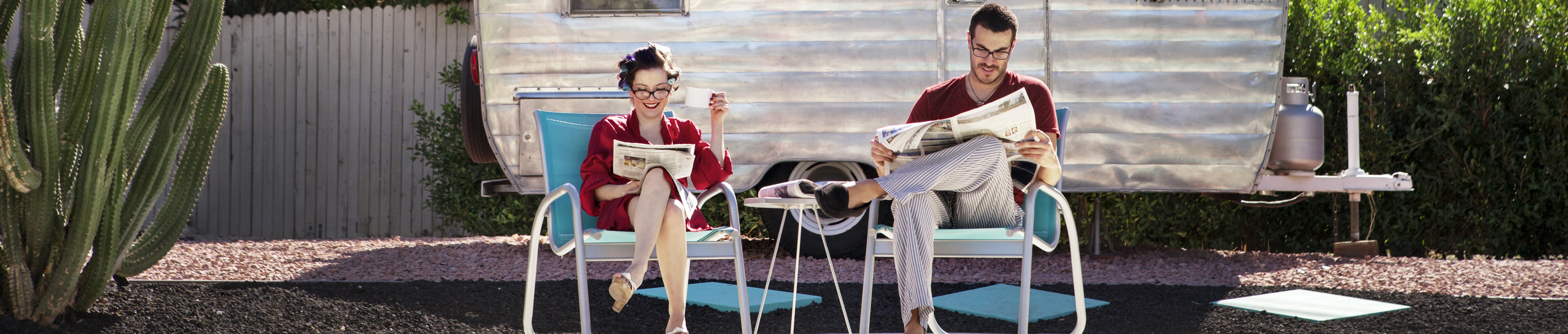 couple-reading-newspaper-while-sitting-on-chair-ag-2022-05-26-00-50-07-utc