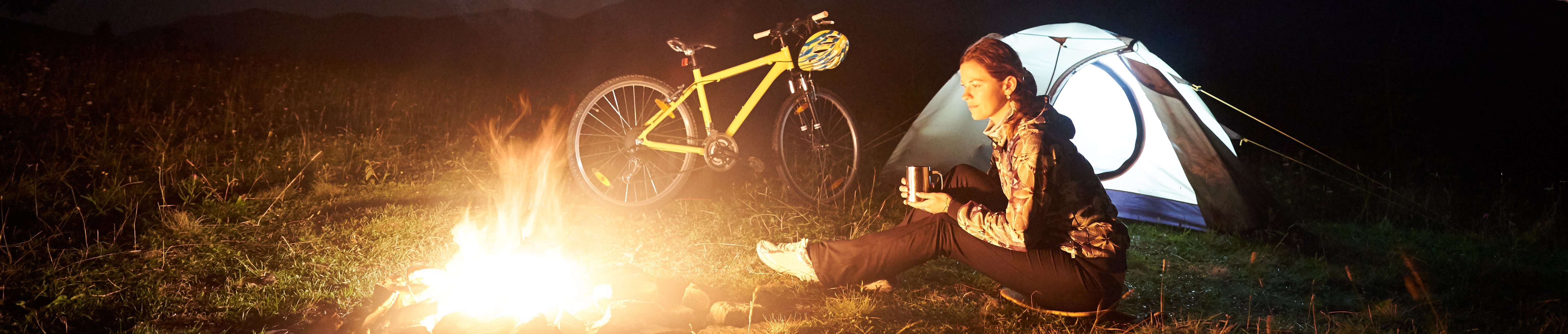 woman-resting-at-night-camping-near-campfire-tour-2022-05-11-23-45-55-utc